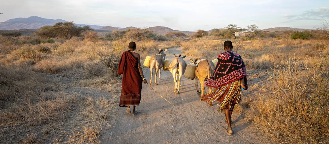 Women carrying water collected from the well