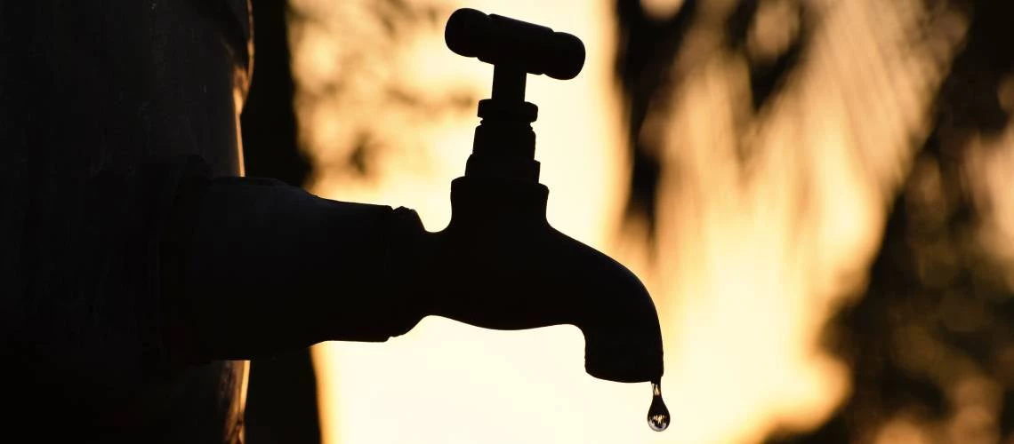 Silhouette of a water tap. Photo: Alameen R/Shutterstock