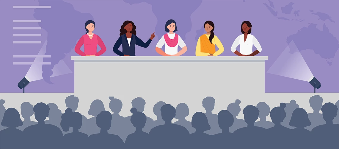 A depiction of multiethnic women sitting at the desk on stage and speak to an audience. | © shutterstock.com