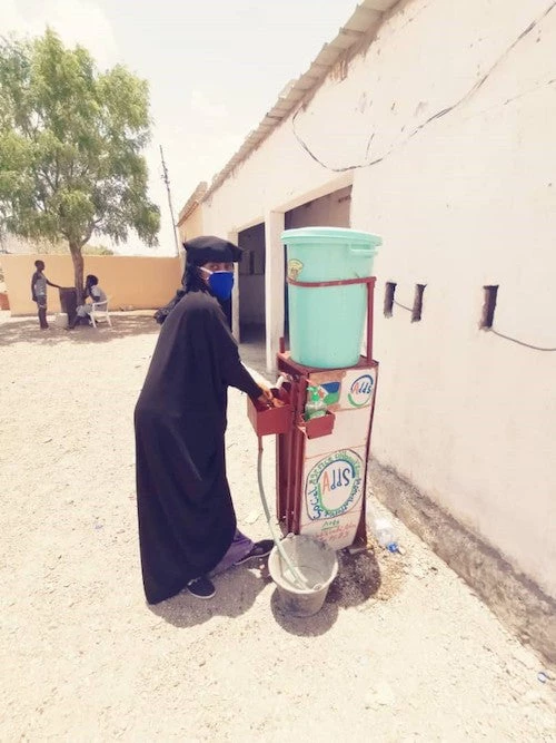 A woman washes her hands before the start of a livelihood training session in Djibouti.