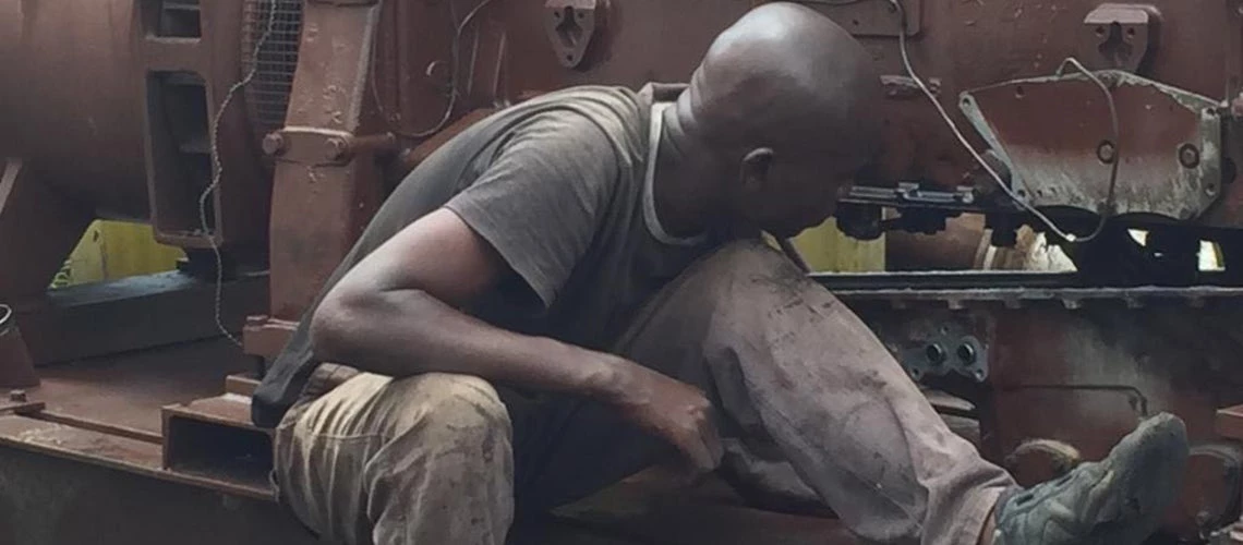 Young apprentice at work at a car mechanic shop. © Photo by Emily Crawford