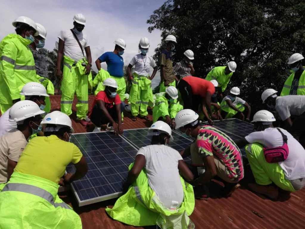 Off-grid Agro-solar Academy students in Sierra Leone installing a solar water pump and learning how to use measuring instruments. © Sierra Leone Skills Development Project, 2021.