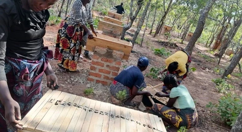 Community members caring for forest apiaries. Photo: TRALARD Project office